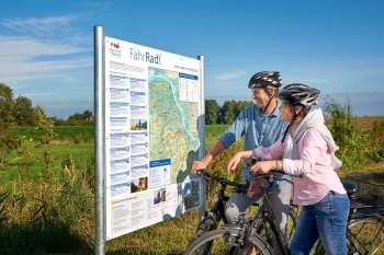 Radfahrer an der Radkarte im Alten Land am Elbstrom © Tourismusverband Landkreis Stade/Elbe e.V. 